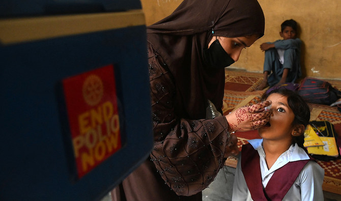 A health worker administers polio vaccine drops to a child during a vaccination campaign in Lahore on October 24, 2022. (AFP/File)