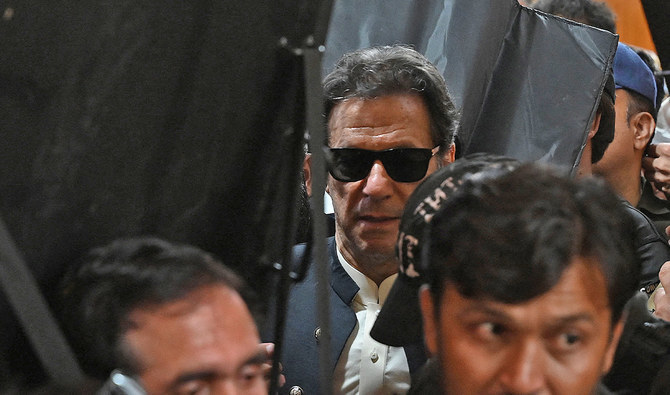 Security personnel with ballistic shields escort former Pakistan's prime minister Imran Khan (C) as he leaves after appearing at the High Court in Lahore, Pakistan, on May 19, 2023. (AFP/File)