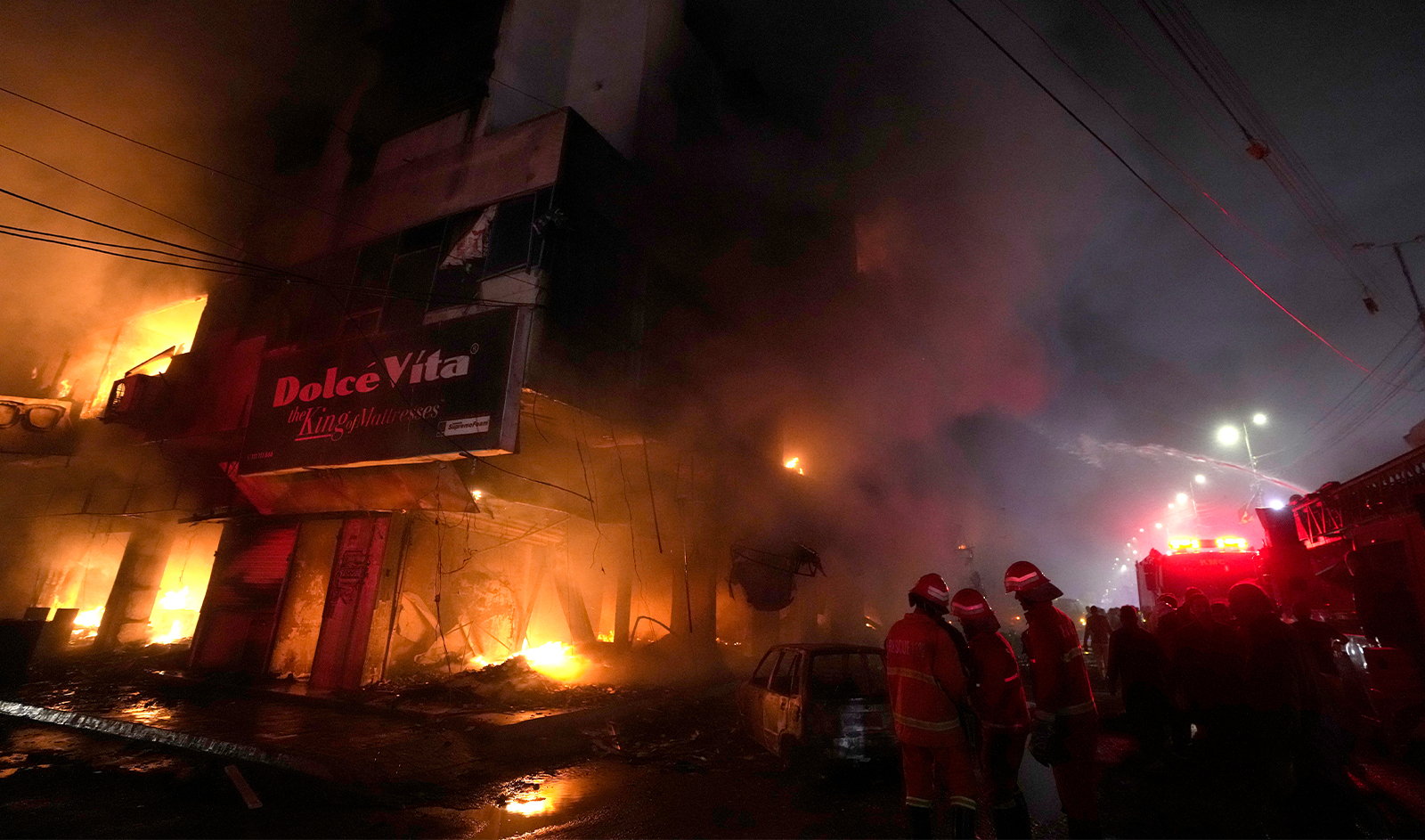 Firefighters struggle to contain a fire at a multi-story commercial building in Karachi, Pakistan, on December 6, 2023. (AP)