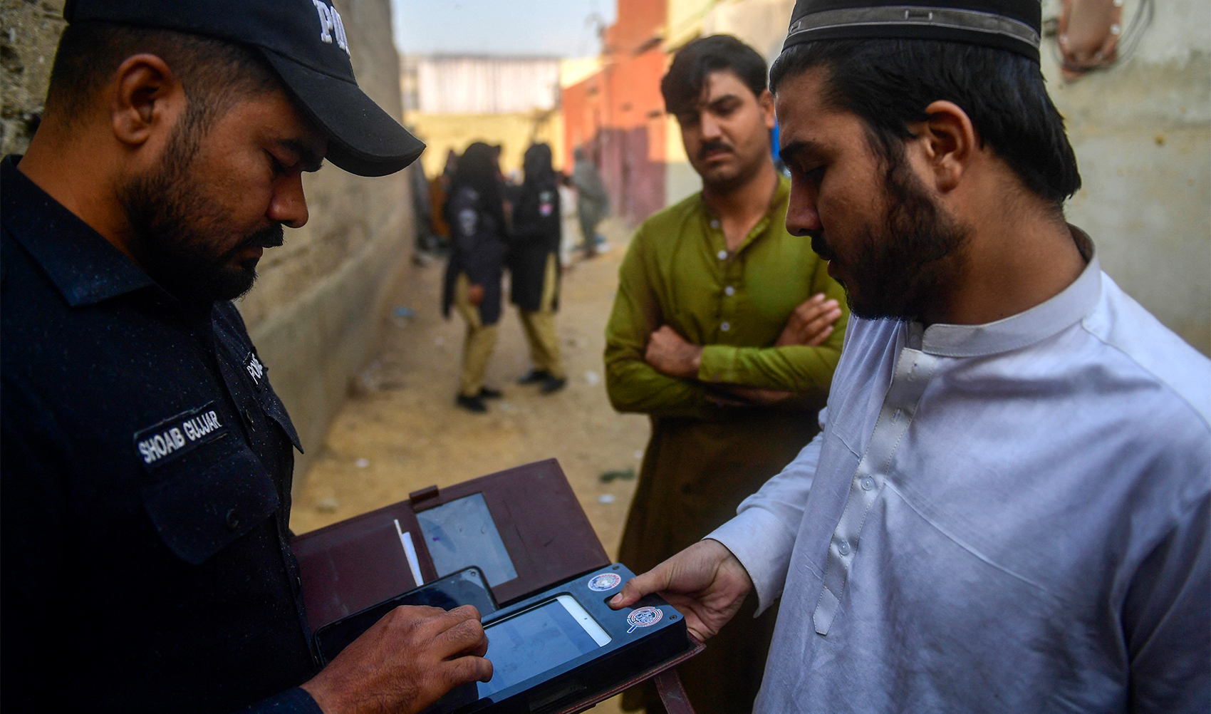 A police personnel tests biometric of an Afghan refugee during a search operation to identify alleged illegal immigrants, on the outskirts of Karachi on November 17, 2023. (AFP/File)