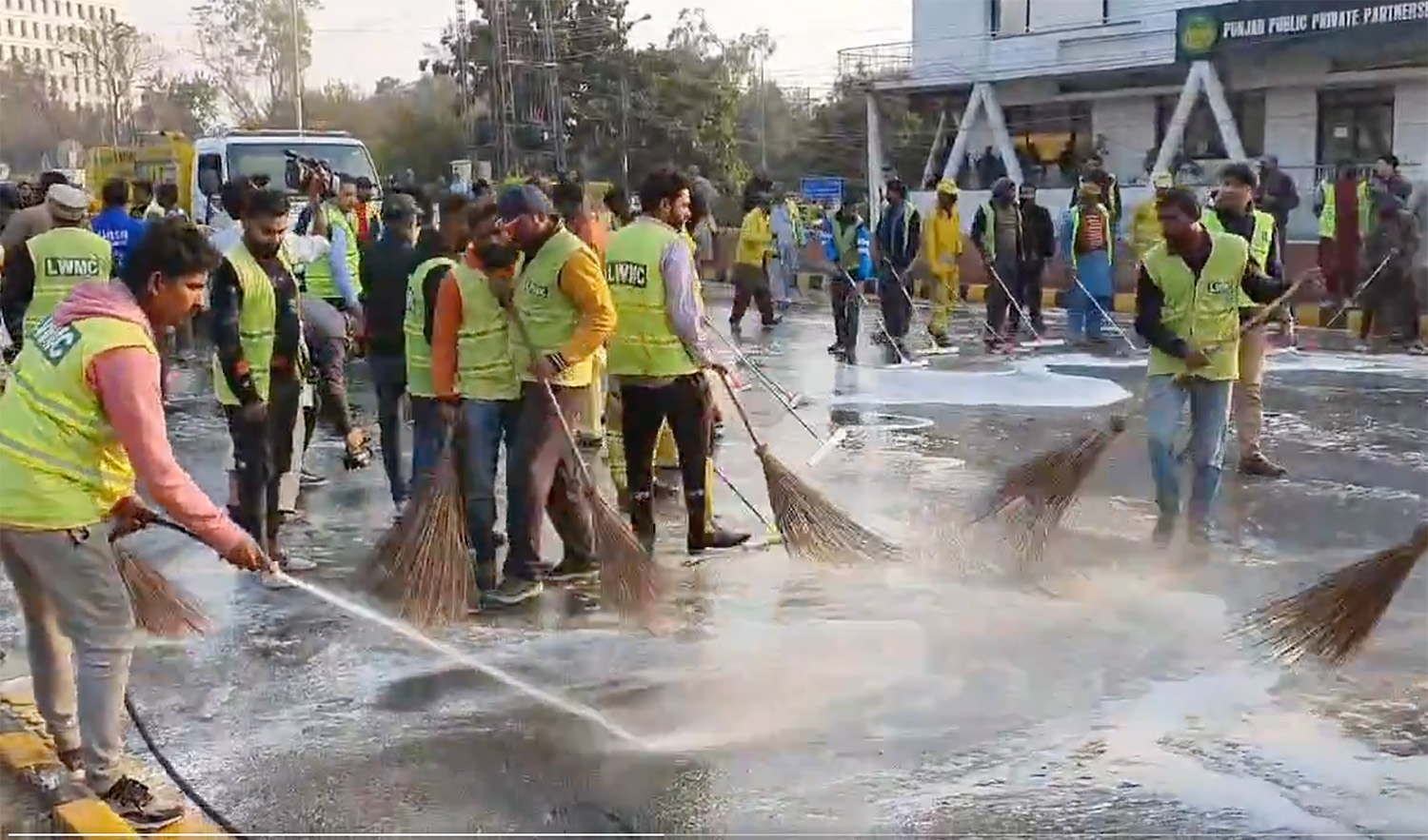 A screenshot from a video captures workers cleaning streets following Punjab Chief Minister Mohsin Naqvi's anti-smog cleanliness initiative in Lahore, Pakistan on December 10, 2023. (Photo courtesy: @MohsinnaqviC42/X)