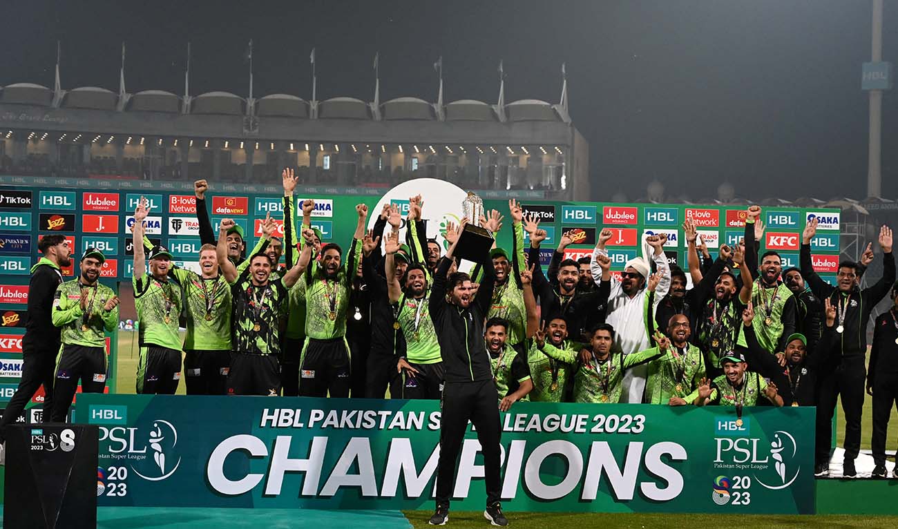Lahore Qalandars' captain Shaheen Shah Afridi (C) holds the PSL final trophy aloft as he celebrates with his team at the Gaddafi Cricket Stadium in Lahore on March 19, 2023. (AFP/File)
