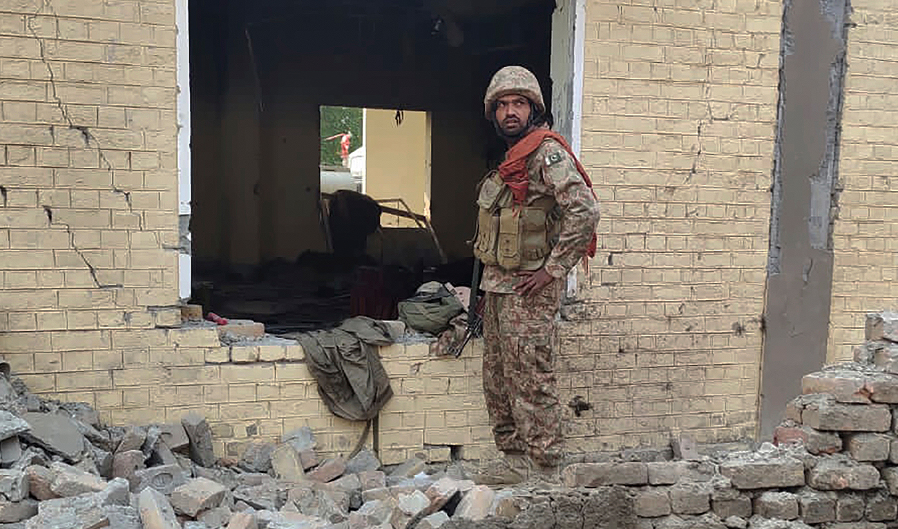 An army soldier examines damages on the site of a bombing at a police station on the outskirts of Dera Ismail Khan, Pakistan, Tuesday, Dec. 12, 2023. (AP)