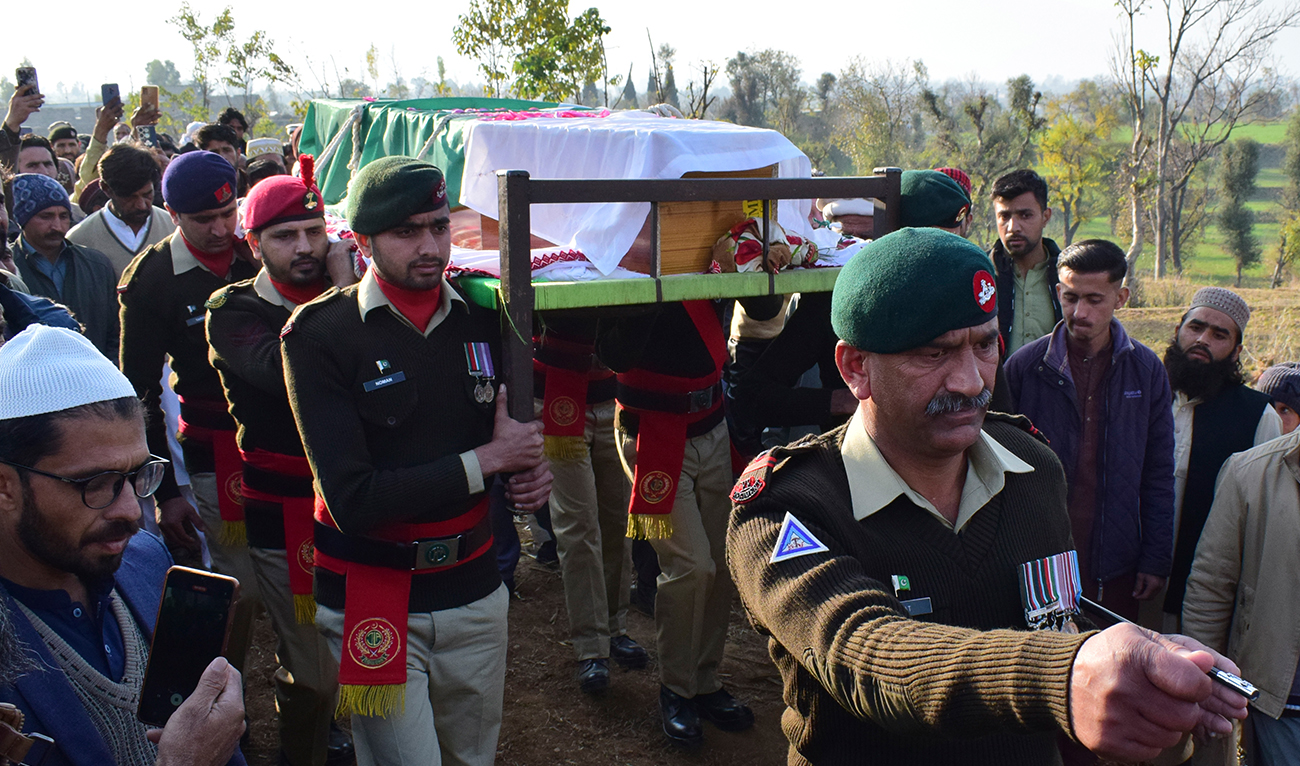 Army soldiers carry the casket of their comrade who was killed in Tuesday's suicide bombing, at a funeral prayer in Chitta Batta village near Mansehra, Pakistan, Wednesday, Dec. 13, 2023. (AP)