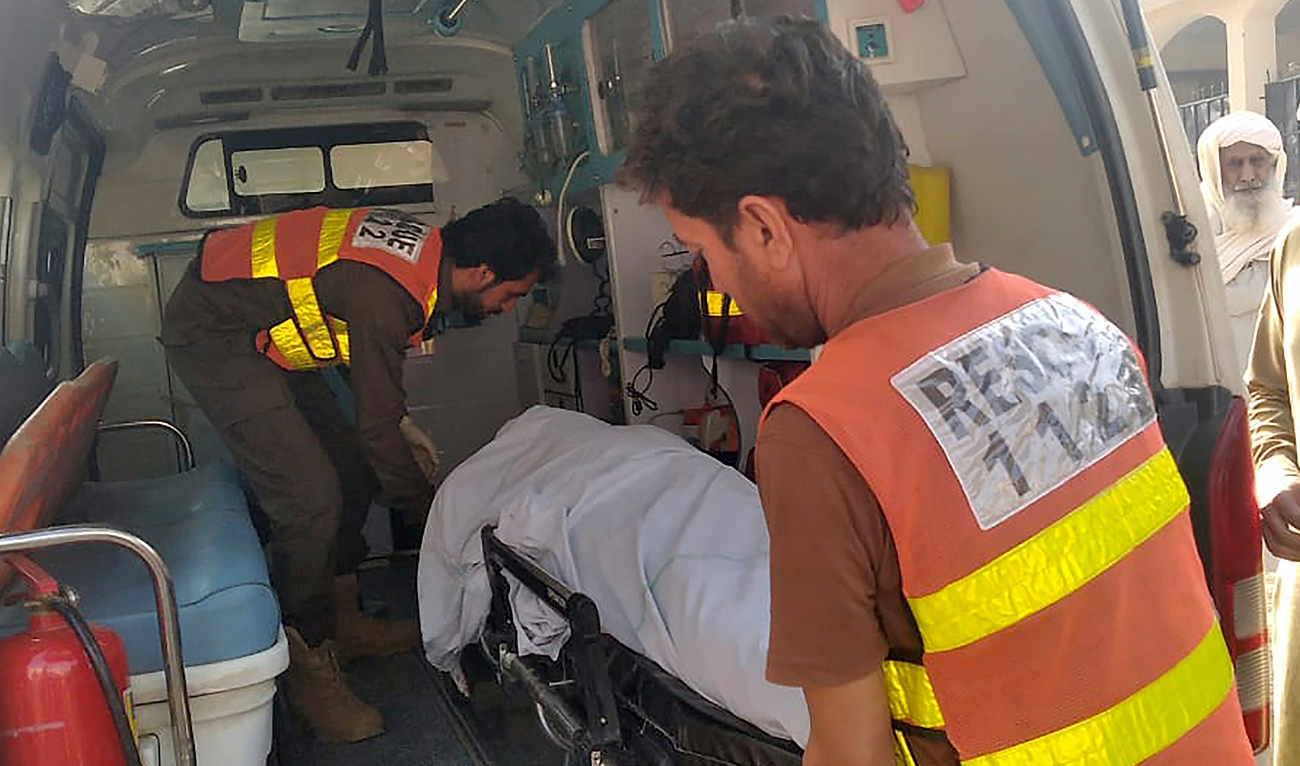 Rescue workers load a body of a police officer, who was killed in a militant attack, into an ambulance at a hospital in Tank, Pakistan, Friday, Dec. 15, 2023. (AP)