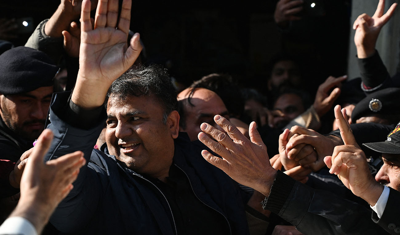 Pakistan's former information minister Fawad Chaudhry gestures as police officials escort him after a hearing at a court in Islamabad on January 27, 2023. (AFP/File)