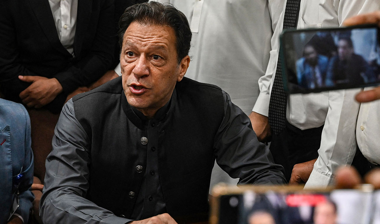 Pakistan's former prime minister, Imran Khan gestures after arriving at a registrar office in Lahore High court to sign surety bonds for bail in various cases, in Lahore on July 3, 2023. (AFP/File)
