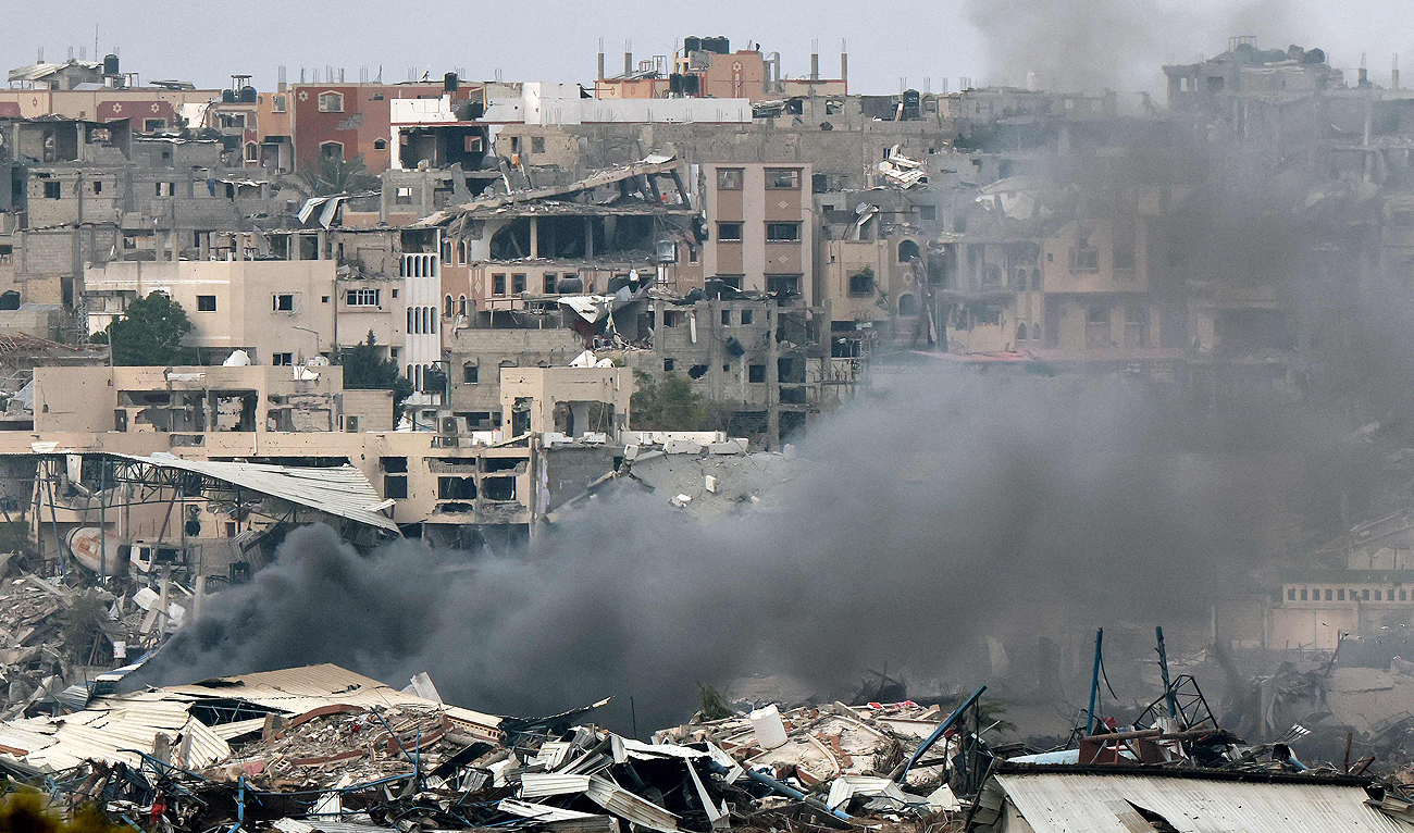 A picture taken from southern Israel near the border with the Gaza Strip on December 21, 2023, shows smoke billowing amid the destruction in northern Gaza resulting from weeks of Israeli bombardment of the Palestinian territory amid ongoing battles with the Hamas militant group. (AFP)