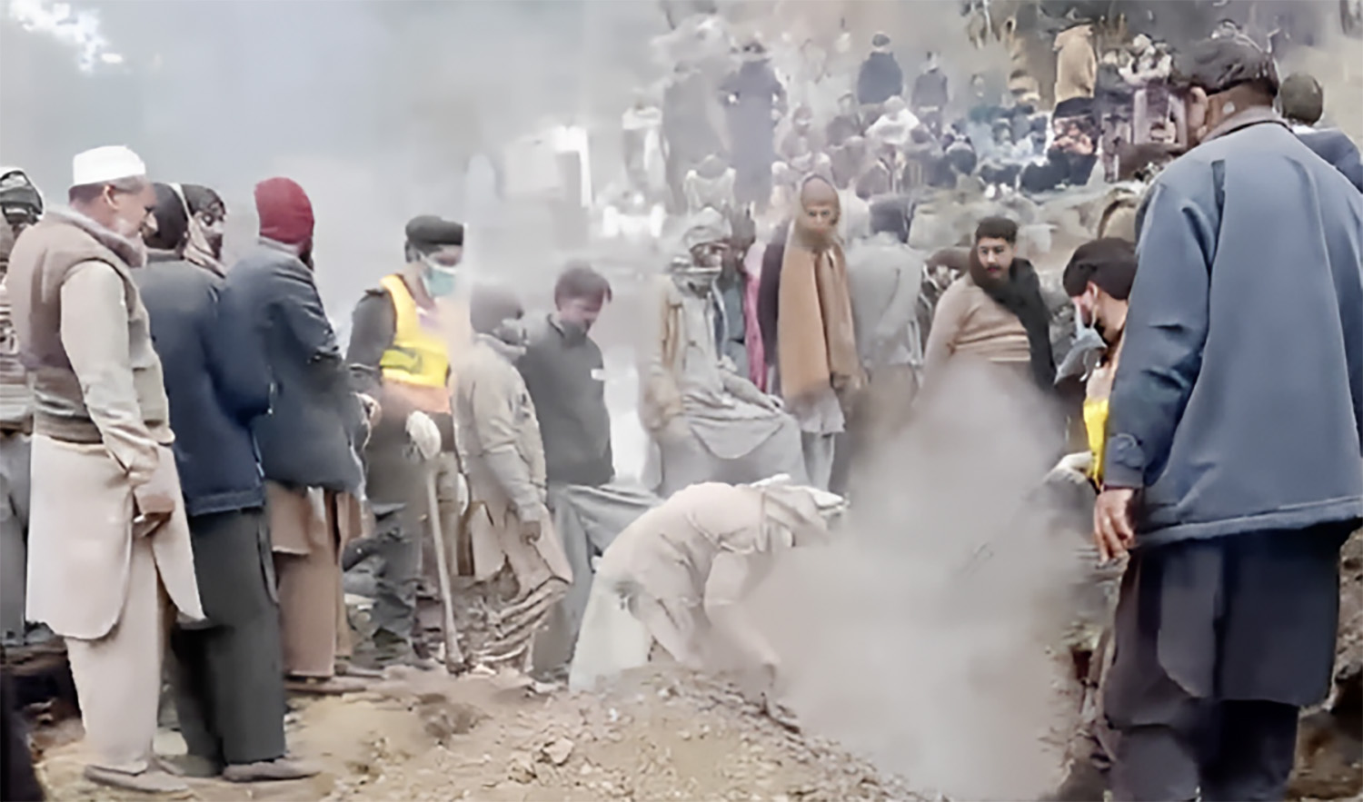Rescue personnel try to recover nine members of a family buried underneath the rubble of a house in Pakistan's northwestern Abbottabad district on December 24, 2023. (Photo courtesy: PC Rescue 1122)