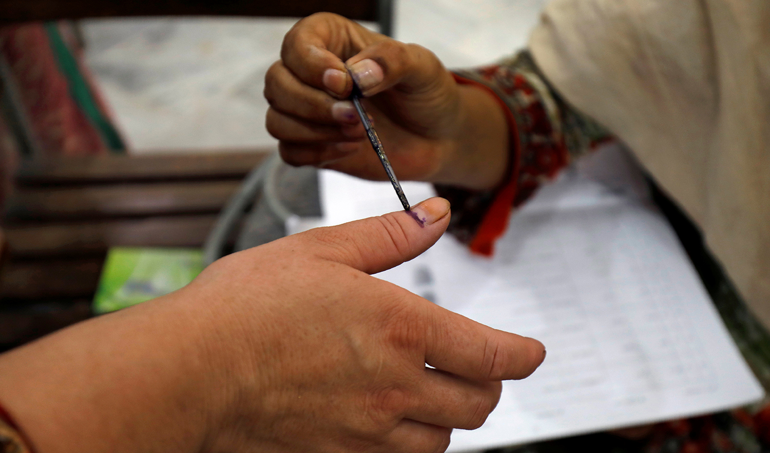 A woman receives an ink mark on her thumb before casting her ballot during general election, at a polling station in Peshawar, Pakistan on July 25, 2018. (REUTERS/File)
