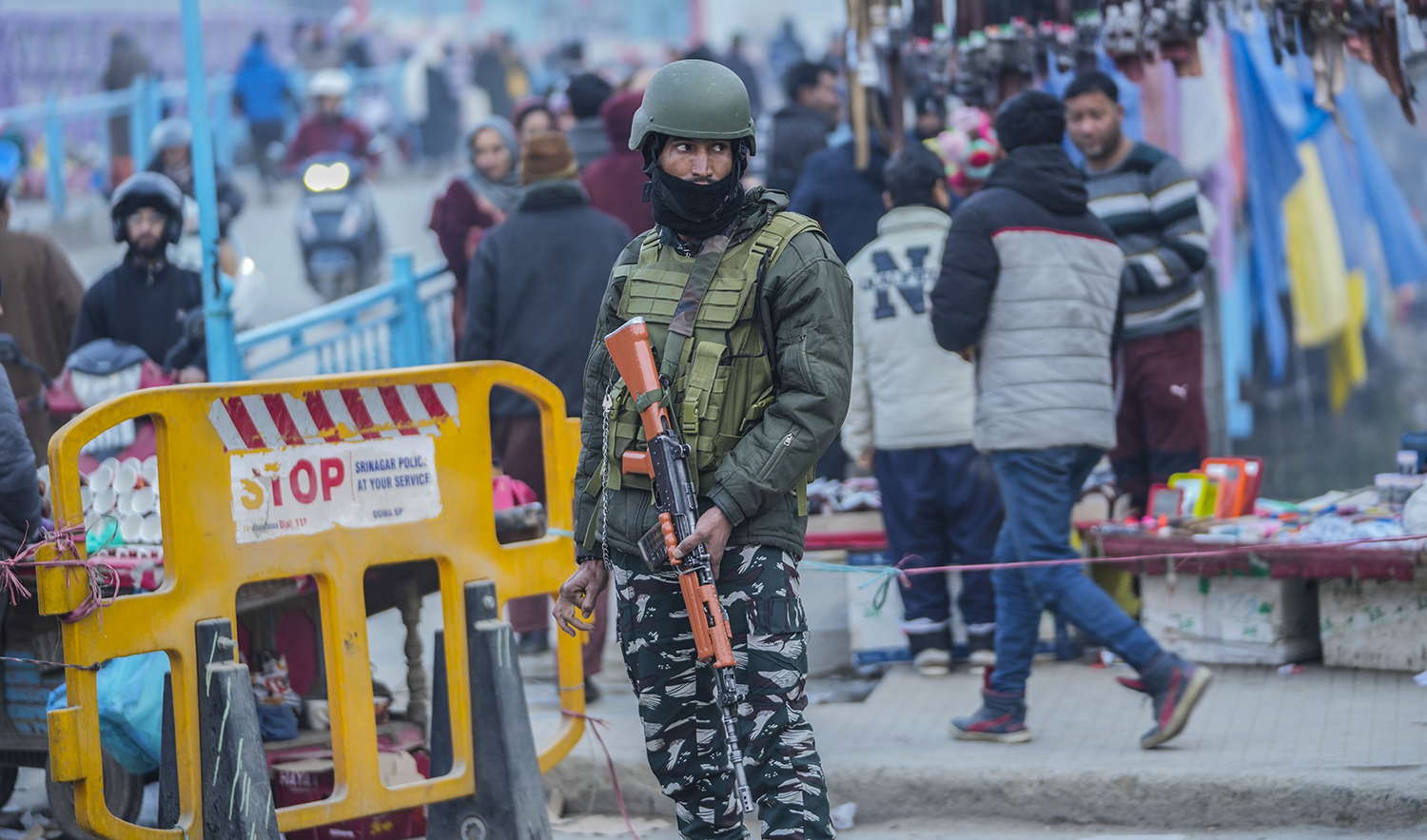 An Indian paramilitary soldier stands guard in Srinagar, Indian-controlled Kashmir, on December 23, 2023. (AP)