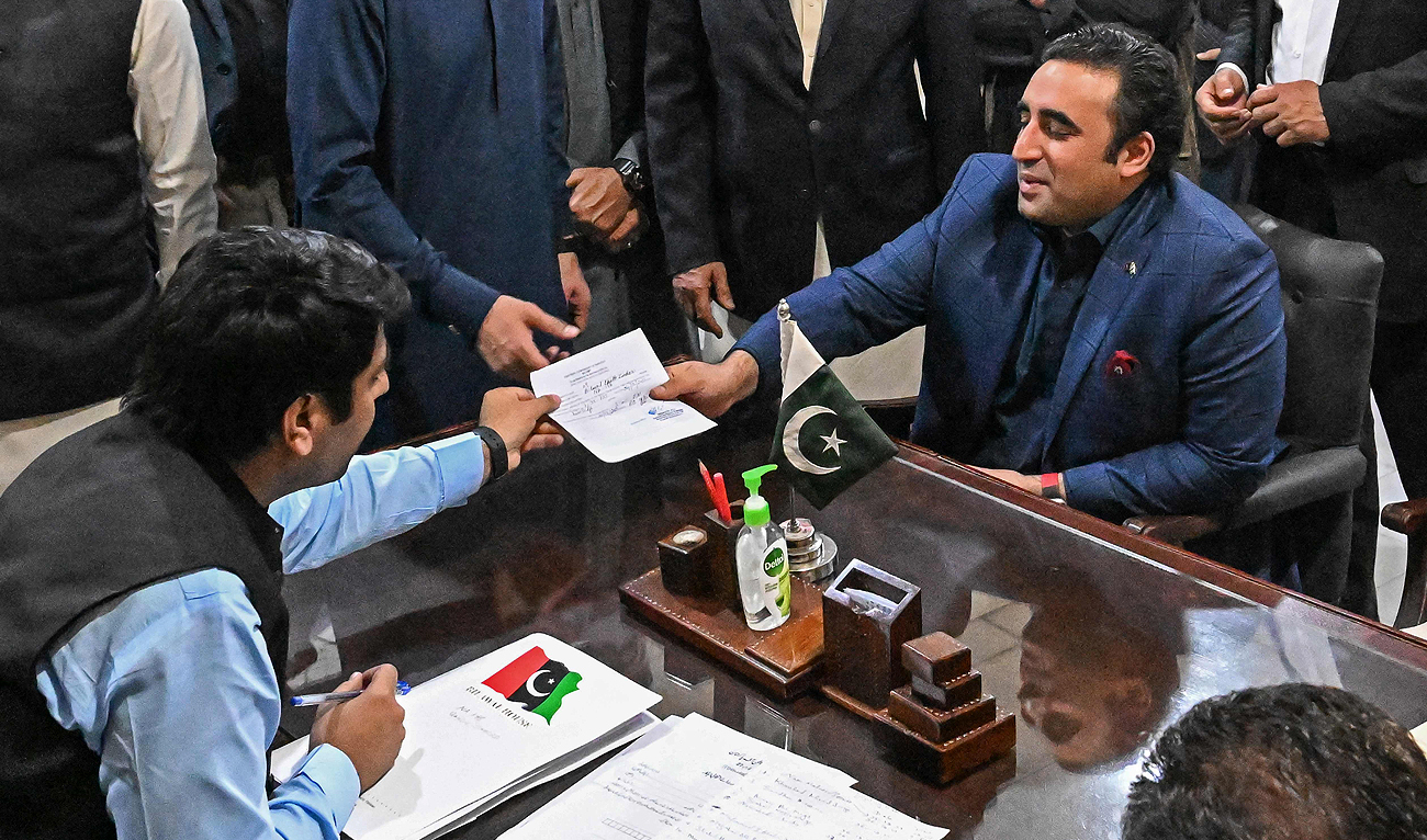 Pakistan Peoples' Party (PPP) chairman Bilawal Bhutto Zardari (R) submits his nomination papers at the deputy commissioner's office in Shahdad Kot of Sindh province on December 24, 2023, ahead of the upcoming 2024 general elections. (AFP)