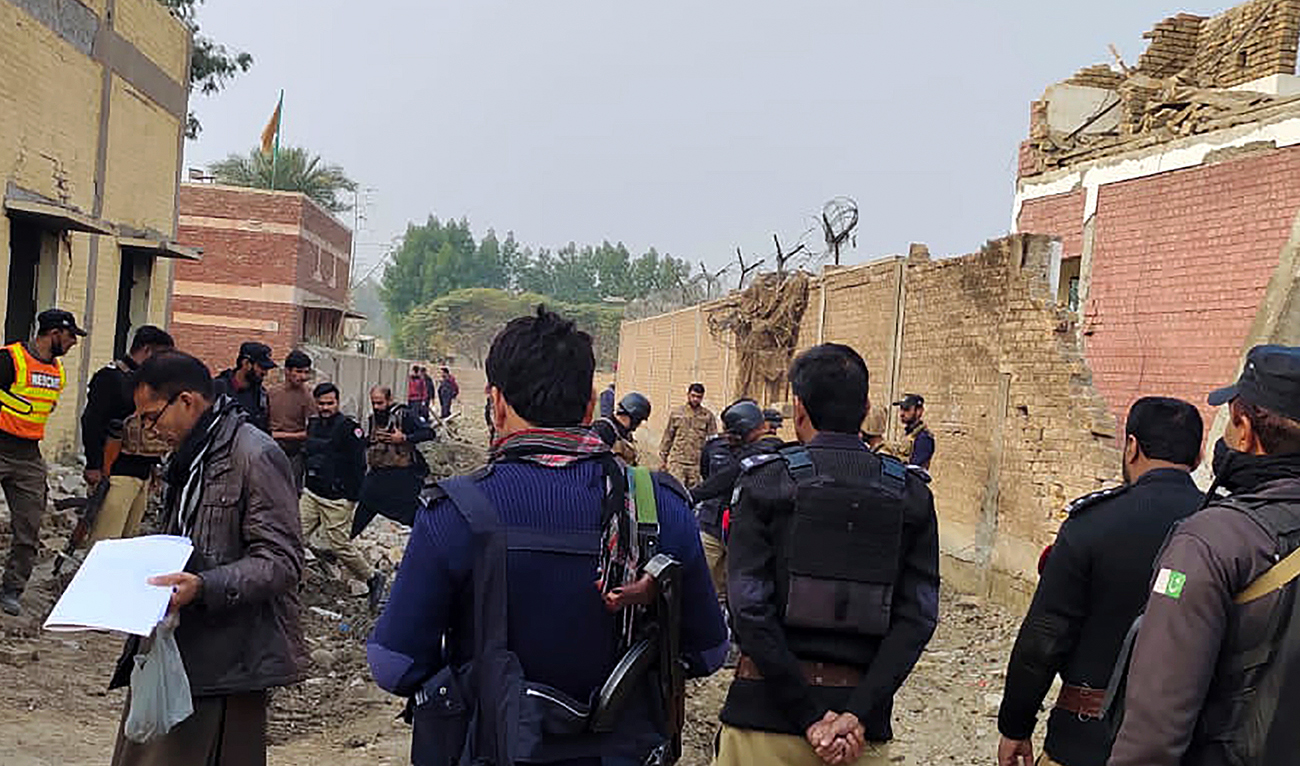 In this file photo, taken on December 12, 2023, security officials examine damages on the site of a bombing at a police station on the outskirts of Dera Ismail Khan. (AP/File)