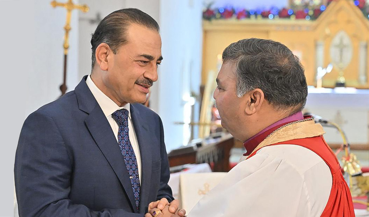 Pakistan Chief of Army Staff Syed Asim Munir, left, meets a member if the Christian community at Christ Church in Rawalpindi, Pakistan on December 25, 2023. (Photo courtesy: ISPR)