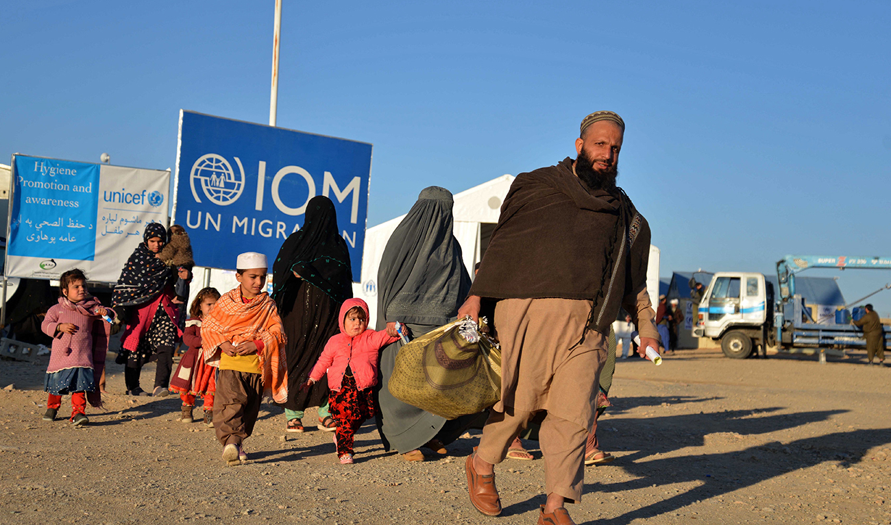Afghan refugees walk at a registration centre, upon their arrival from Pakistan in Takhta Pul district of Kandahar province on December 18, 2023. (AFP/File)