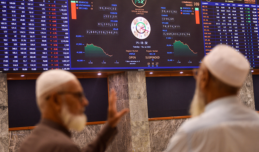 Stockbrokers speak while monitoring the share prices during a trading session at the Pakistan Stock Exchange (PSX) in Karachi on July 19, 2022. (AFP/File)