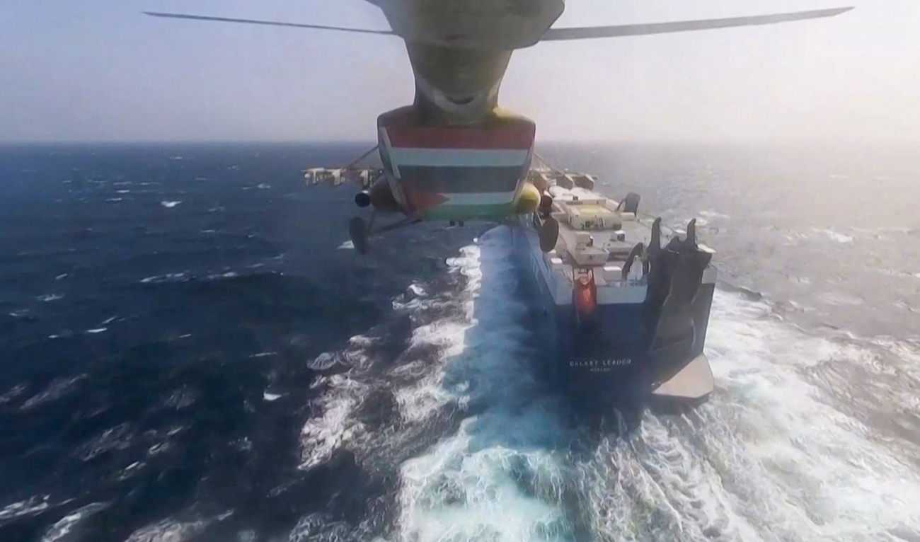 A grab from handout footage released by Yemen's Huthi Ansarullah Media Centre on November 19, 2023, reportedly shows members of the rebel group during the capture of an Israel-linked cargo vessel at an undefined location in the Red Sea. (AFP/File)