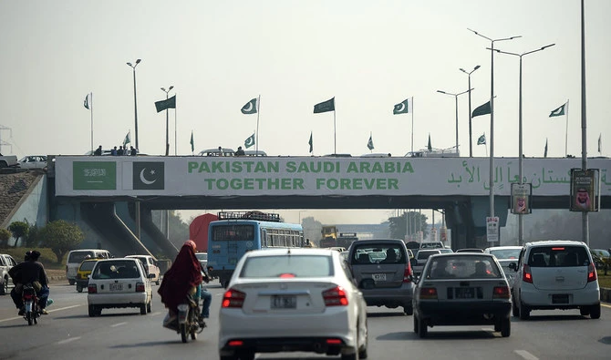 Pakistani commuters drive their vehicles under a banner welcoming Saudi Arabian Crown Prince Mohammed bin Salman displayed on a bridge, ahead of his arrival, in Islamabad on February 15, 2019. (AFP/File)
