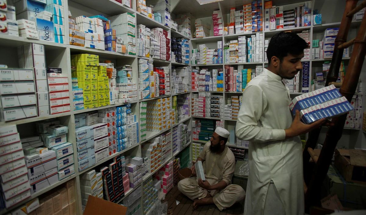 Men arrange medicine packs on the shelves of a pharmacy in Peshawar, Pakistan on May 23, 2018. (REUTERS/File)