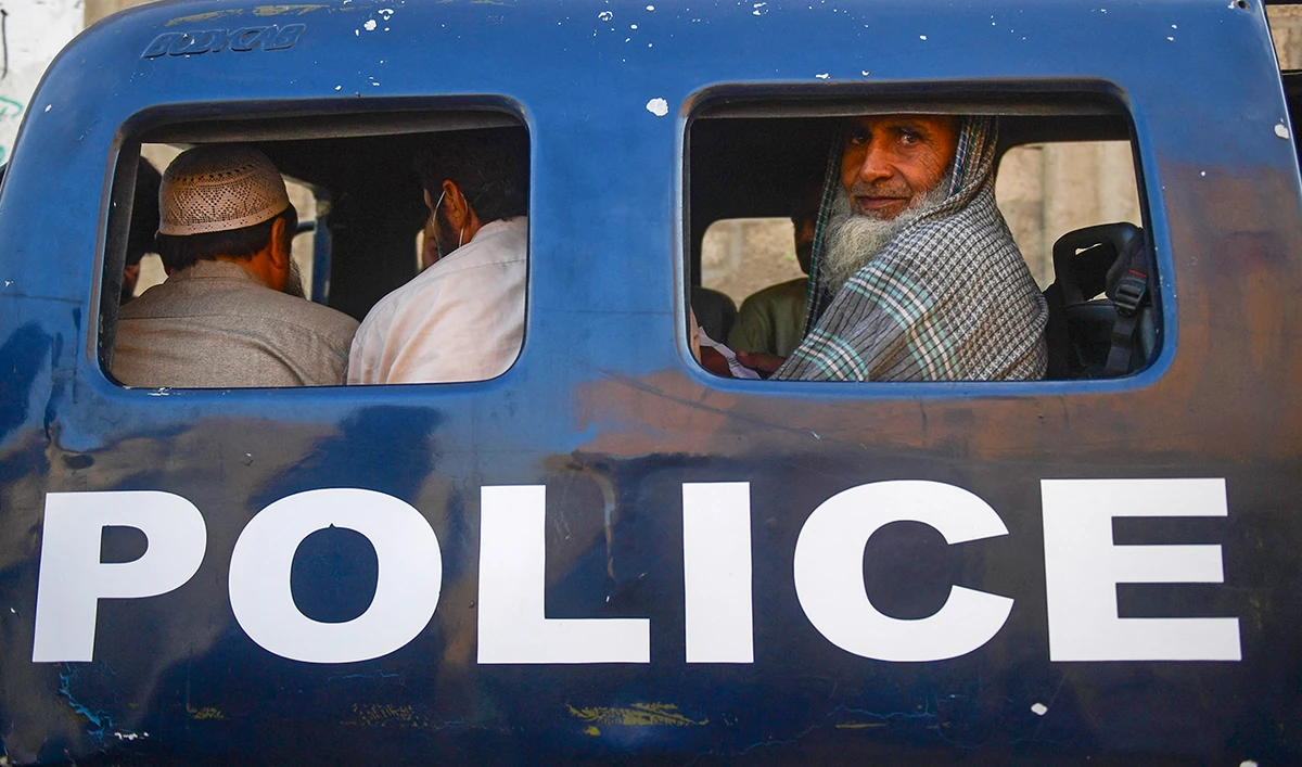 Detained Afghan refugees sit in a van during a search operation to identify alleged illegal immigrants, on the outskirts of Karachi on November 17, 2023. (AFP/File)