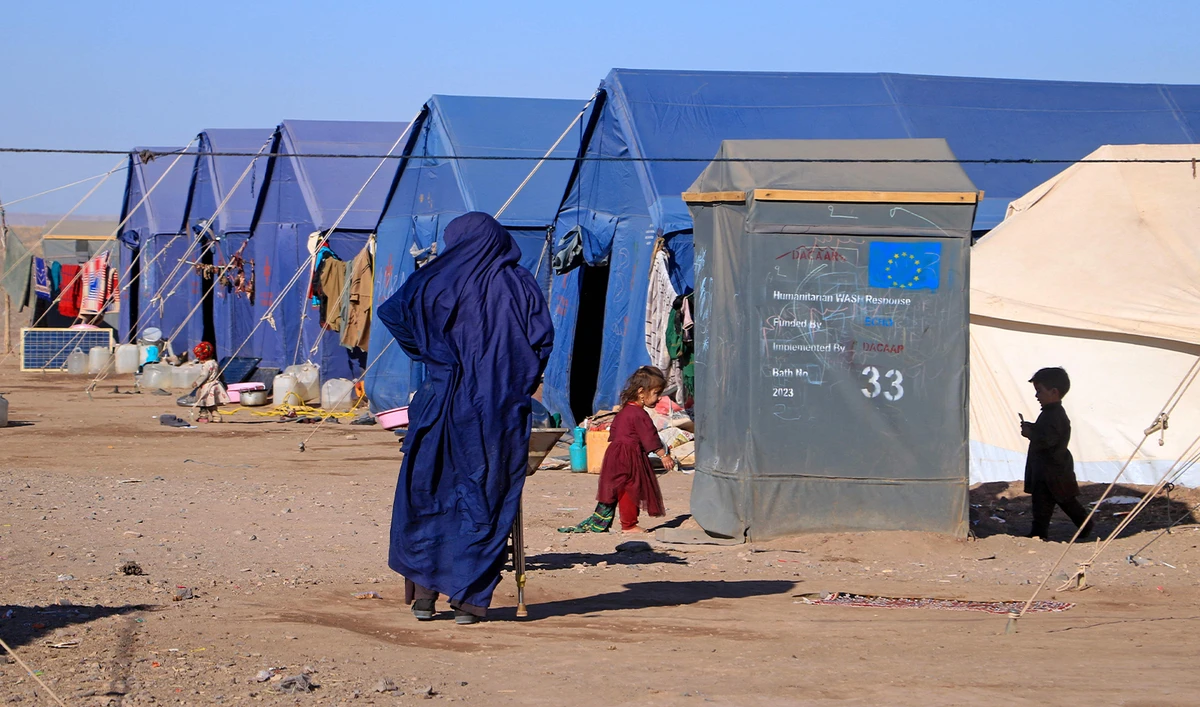 Afghan children play near their makeshift tents at Nayeb Rafi village in Zendeh Jan district of Herat province on December 10, 2023. (AFP/File)