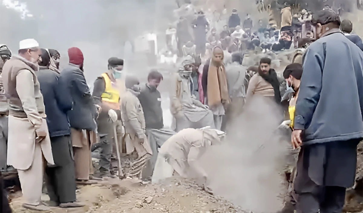 Rescue personnel try to recover nine members of a family buried underneath the rubble of a house in Pakistan's northwestern Abbottabad district on December 24, 2023. (Photo courtesy: PC Rescue 1122)