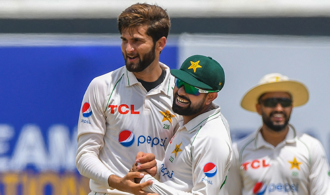 Pakistan’s Shaheen Shah Afridi (L) celebrates with captain Babar Azam (C) after taking the wicket of Sri Lanka's Dhananjaya de Silva (not pictured) during the first day of the first cricket Test match between Sri Lanka and Pakistan at the Galle International Cricket Stadium in Galle on July 16, 2022. (AFP/File)