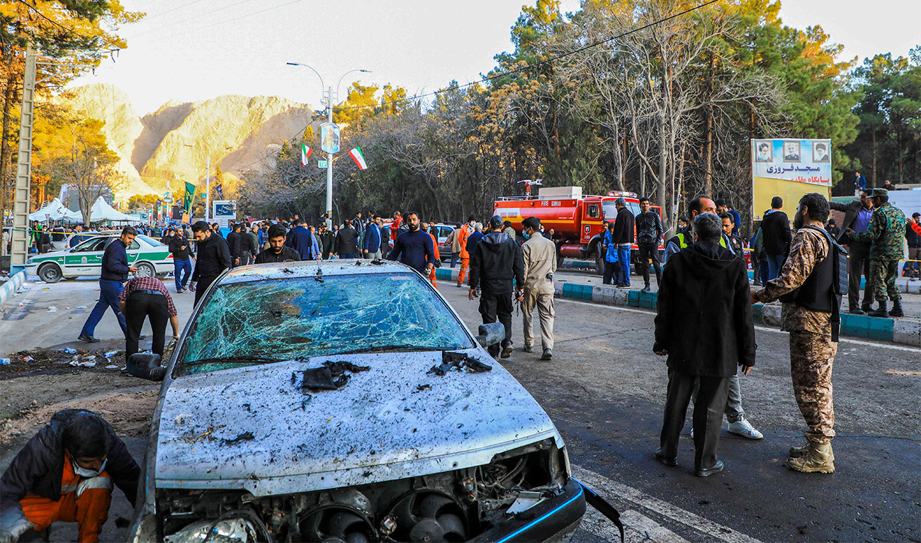 This picture shows people and Iranian emergency personnel at the where two explosions in quick succession struck a crowd marking the anniversary of the 2020 killing of Guards general Qasem Soleimani, near the Saheb al-Zaman Mosque in the southern Iranian city of Kerman on January 3, 2024. (AFP)