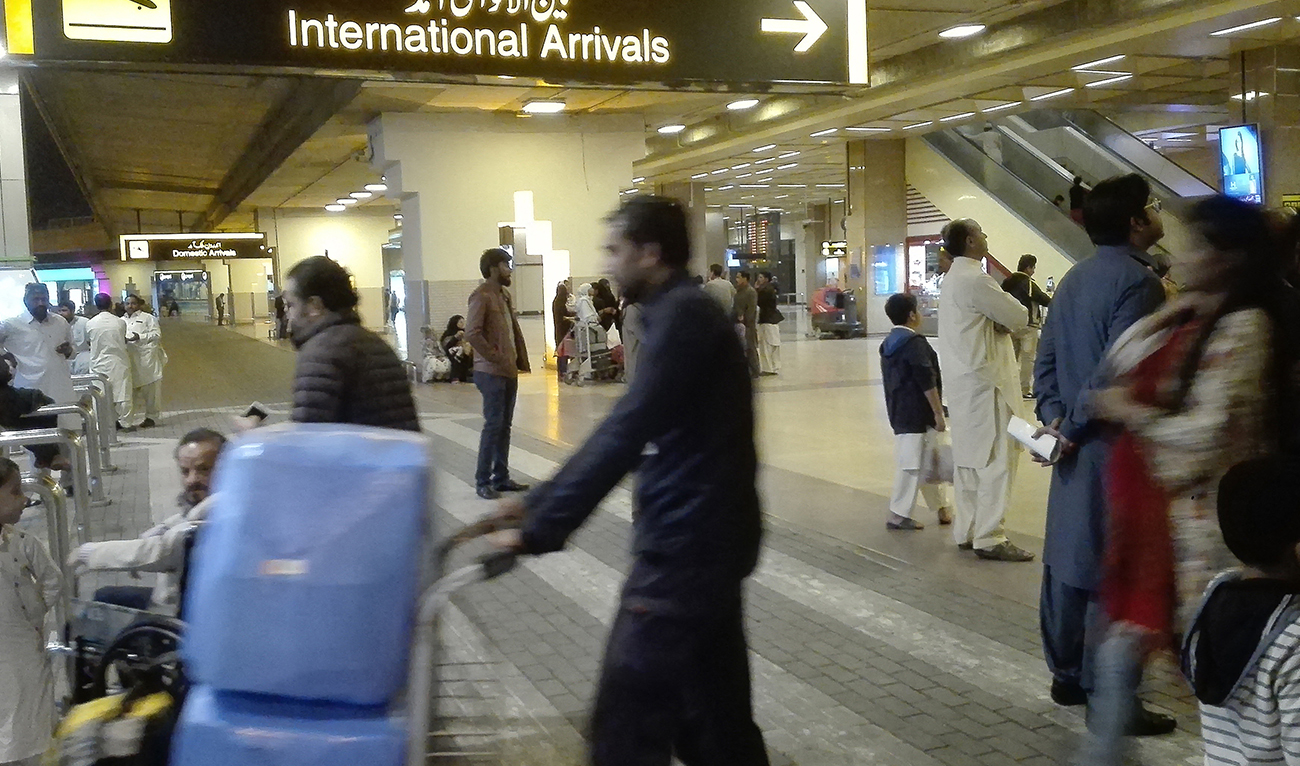 Passengers walk after their arrival at the Jinnah International Airport in Karachi on January 31, 2020. (AFP/File)