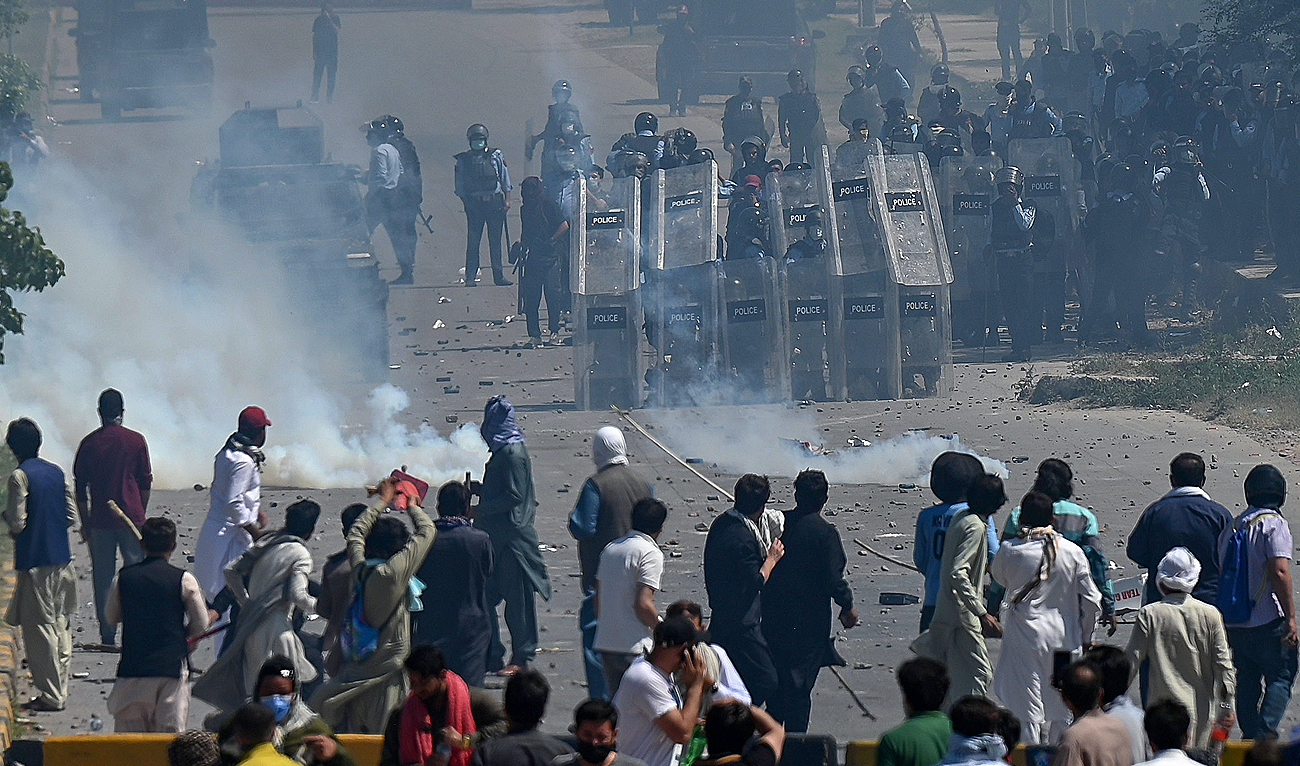 In this file photo, taken on May 10, 2023, supporters of former Pakistan's Prime Minister Imran Khan clash with policemen during a protest against the arrest of their leader, in Islamabad. (AFP/File)