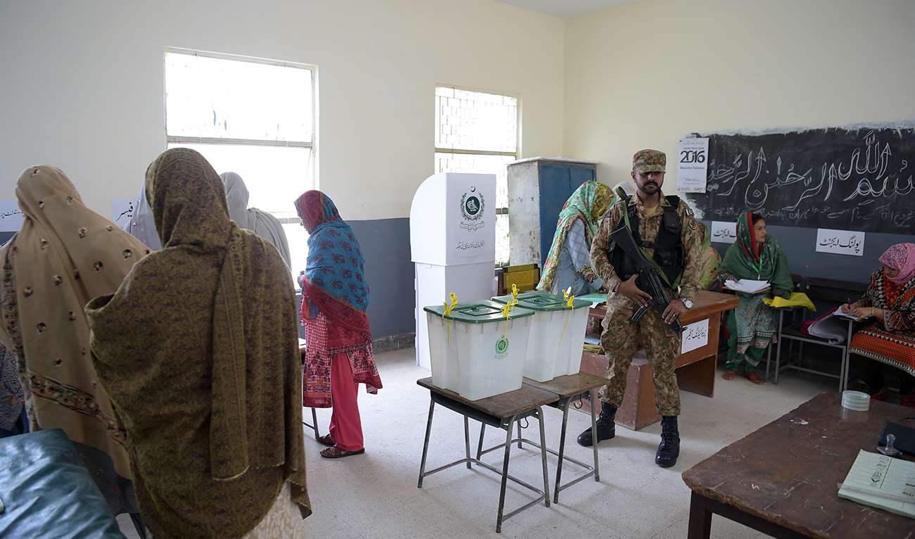 A Pakistani soldier stands guard next to ballot boxes during Pakistan's general election at a polling station in Islamabad on July 25, 2018. (AFP/File)