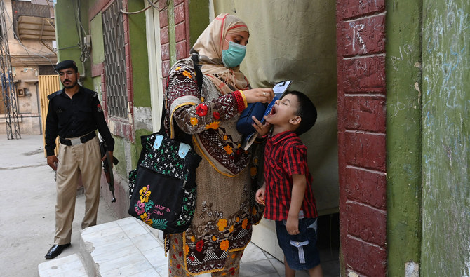 A health worker administers polio vaccine drops to a child during a vaccination campaign in Peshawar, Pakistan on May 22, 2023. (AFP/File)