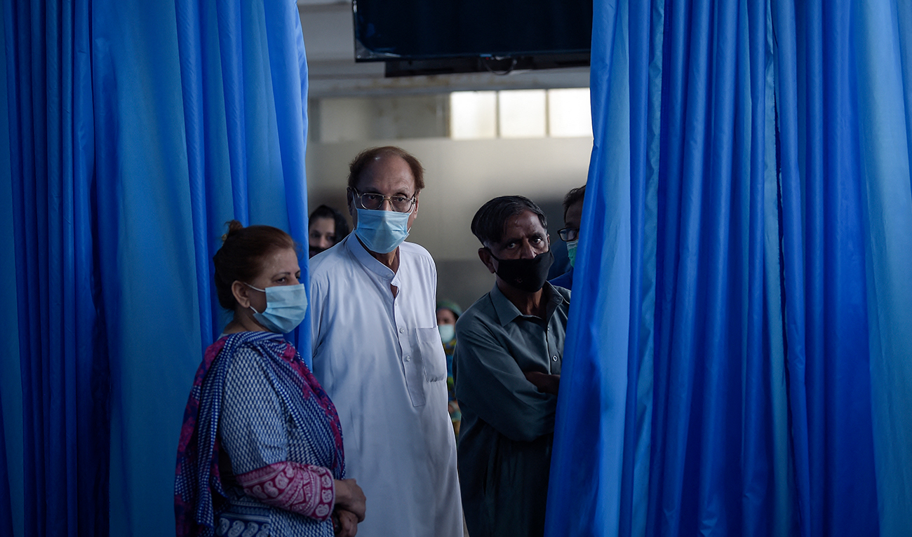 People wait for their turn to get a Covid-19 coronavirus Sinovac vaccine at the Red Crescent vaccination centre in Rawalpindi on May 24, 2021. (ADP/File)