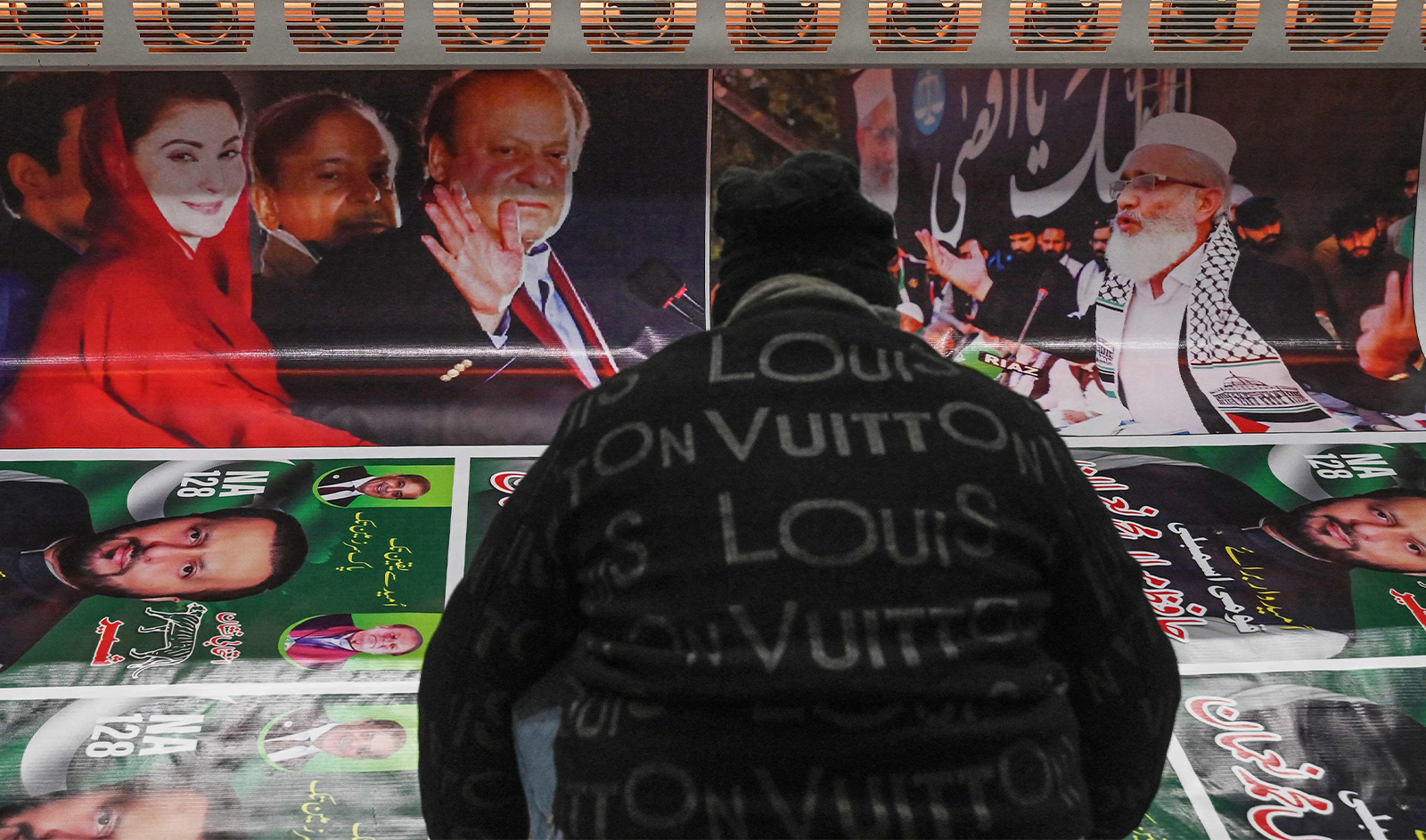 A worker prints election campaign posters of Pakistan's former Prime Minister Nawaz Sharif (top 3L) and his daughter Maryam Nawaz (top L) at a printer in Lahore on January 9, 2024, ahead of the upcoming general elections. (AFP/File)