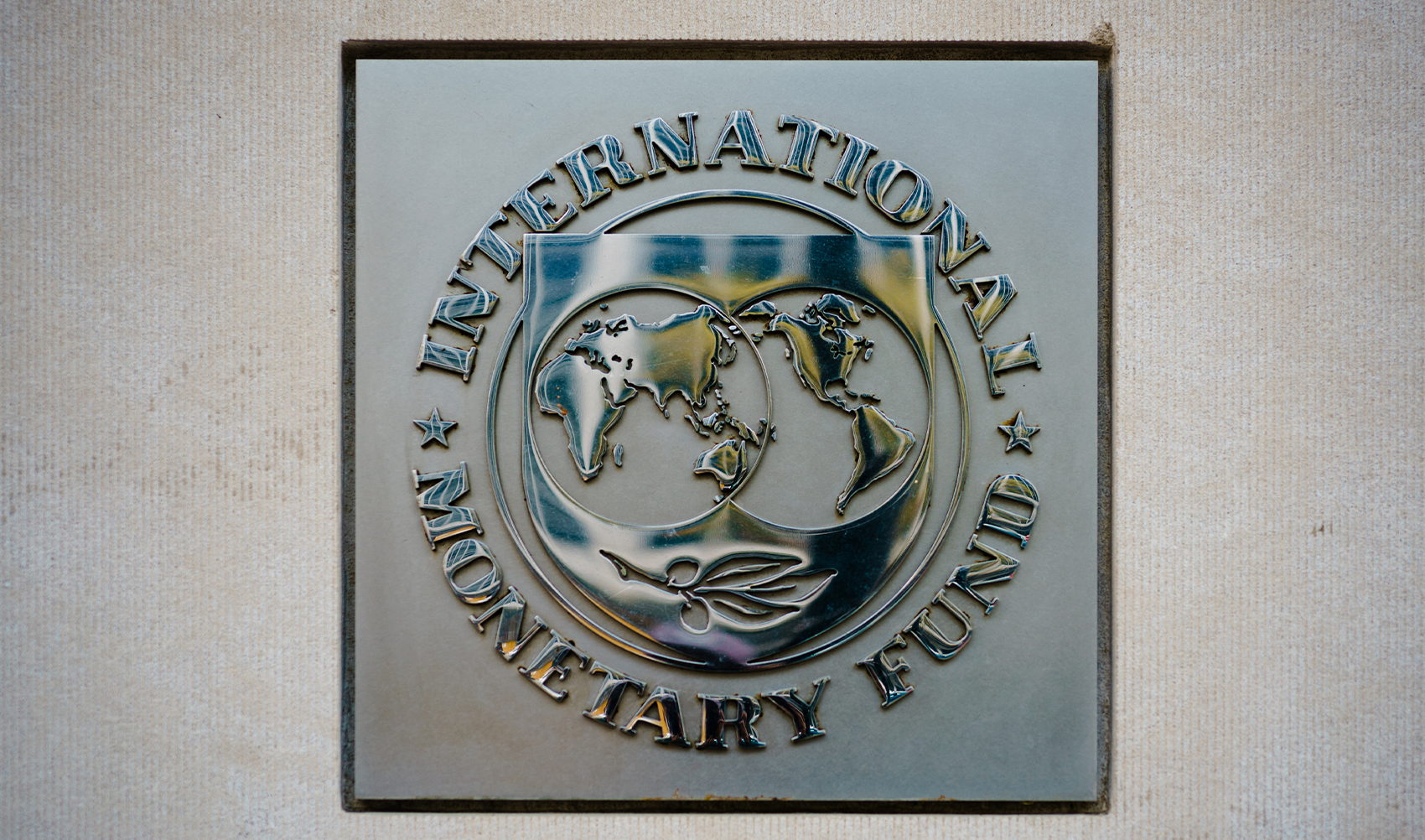 The seal of the International Monetary Fund (IMF) is seen outside of a headquarters building in Washington, DC on April 7, 2021. (AFP/File)