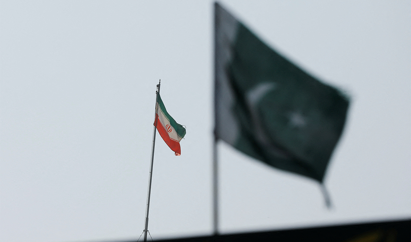 The flag of Iran is seen over its consulate building, with Pakistan's flag in the foreground, after the Pakistani foreign ministry said the country conducted strikes inside Iran targeting separatist militants, two days after Tehran said it attacked Israel-linked militant bases inside Pakistani territory, in Karachi, Pakistan, on January 18, 2024. (REUTERS)