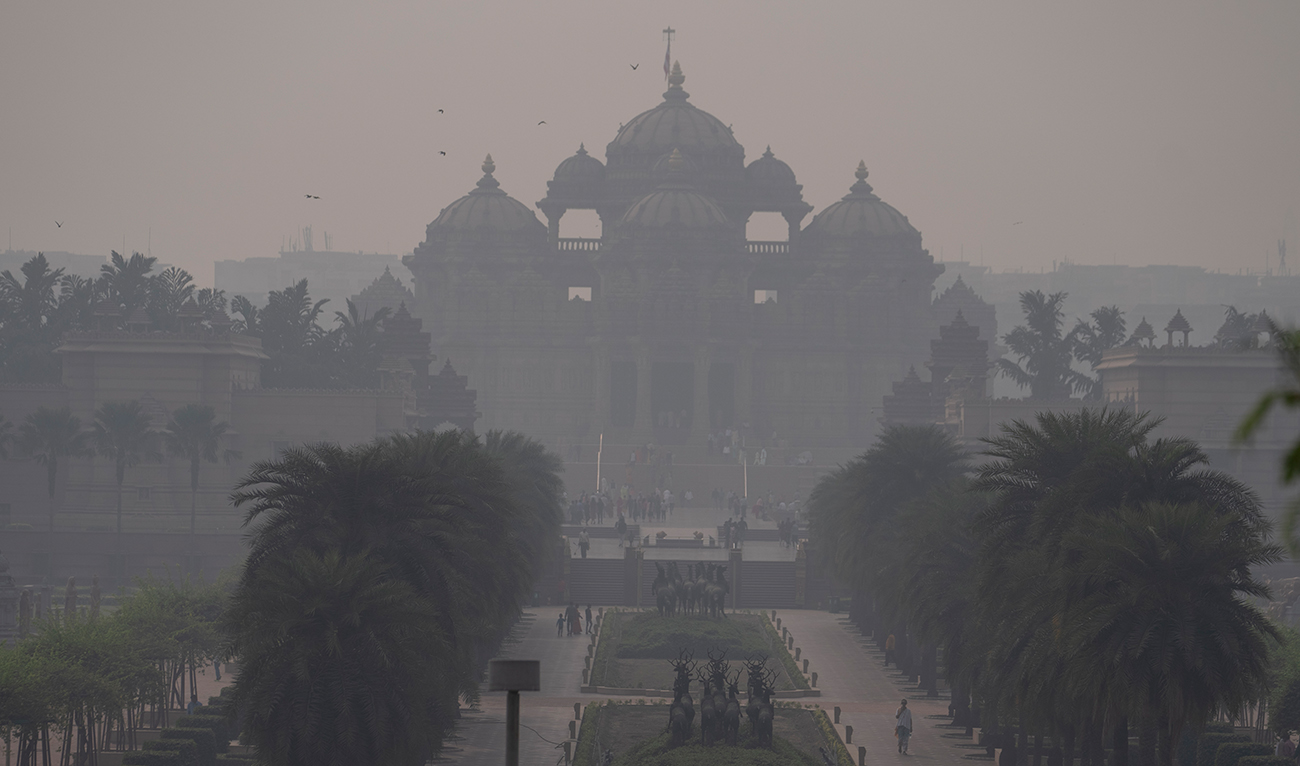 People visiting the Akshardham temple are visible through a thick smog in New Delhi, India, Wednesday, Nov. 8, 2023. (AP)
