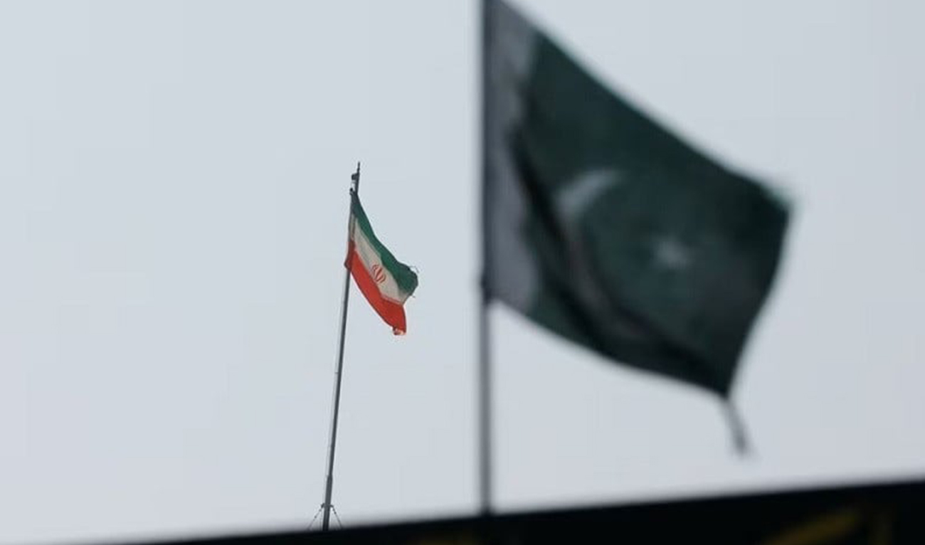 The flag of Iran is seen over its consulate building, with Pakistan's flag in the foreground, in Karachi, Pakistan on January 18, 2024. (REUTERS/File)