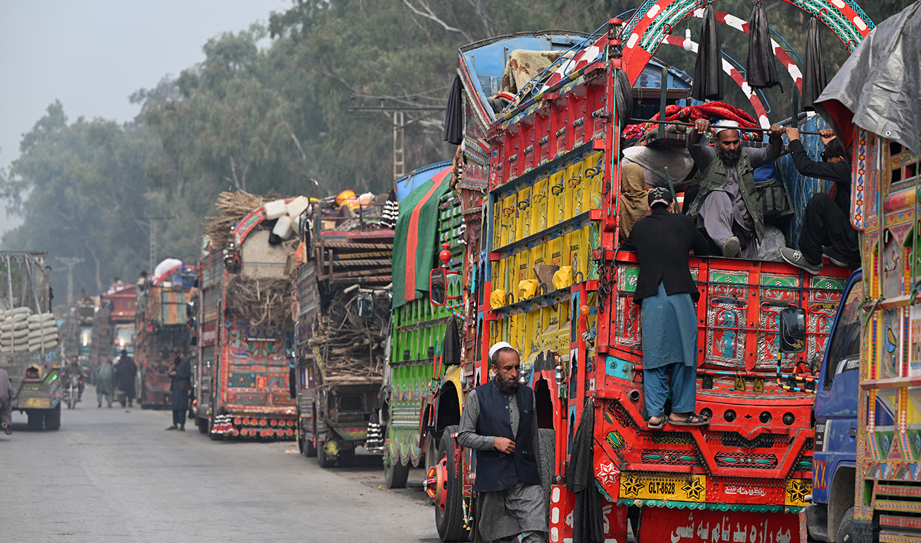 This photo taken on November 23, 2023 shows Afghan refugee on a truck after visiting the United Nations High Commissioner for Refugees (UNHCR) Azakhel Voluntary Repatriation Centre in Nowshera, Pakistan. (AFP/File)