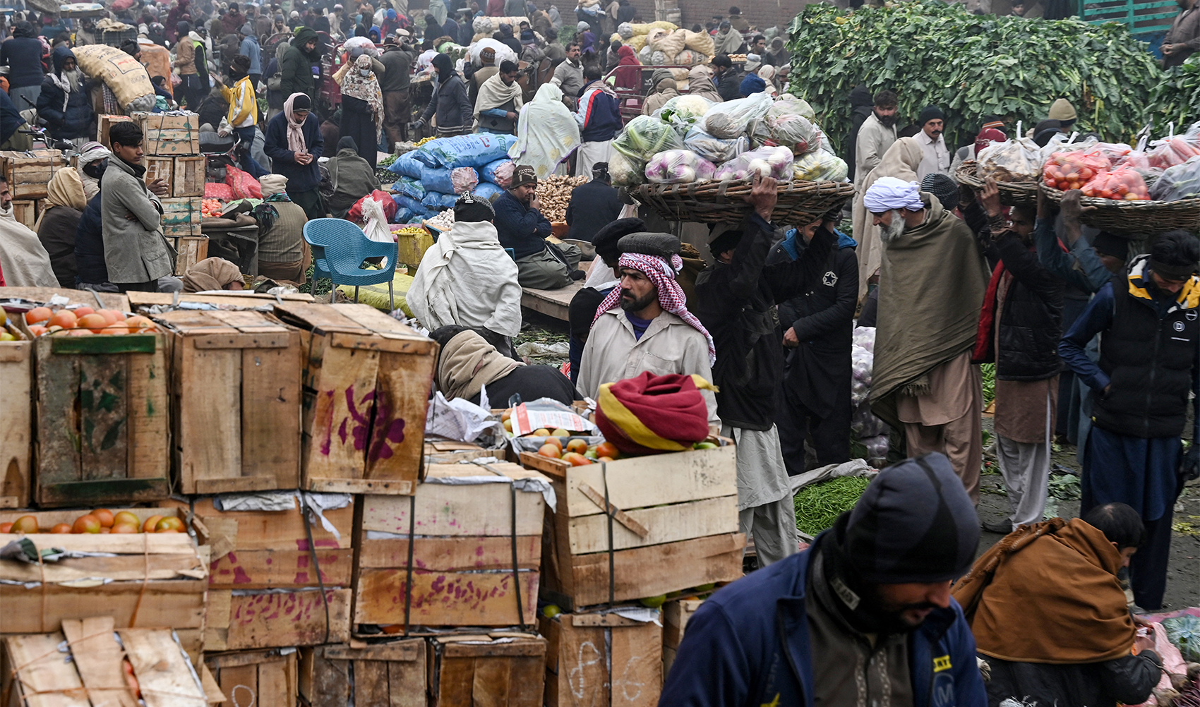 Vendors sell vegetables at a market in Lahore, Pakistan, on January 15, 2024. (AFP)