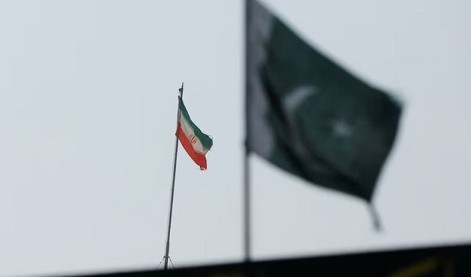 The flag of Iran is seen over its consulate building, with Pakistan's flag in the foreground, in Karachi, Pakistan on January 18, 2024. (REUTERS/File)