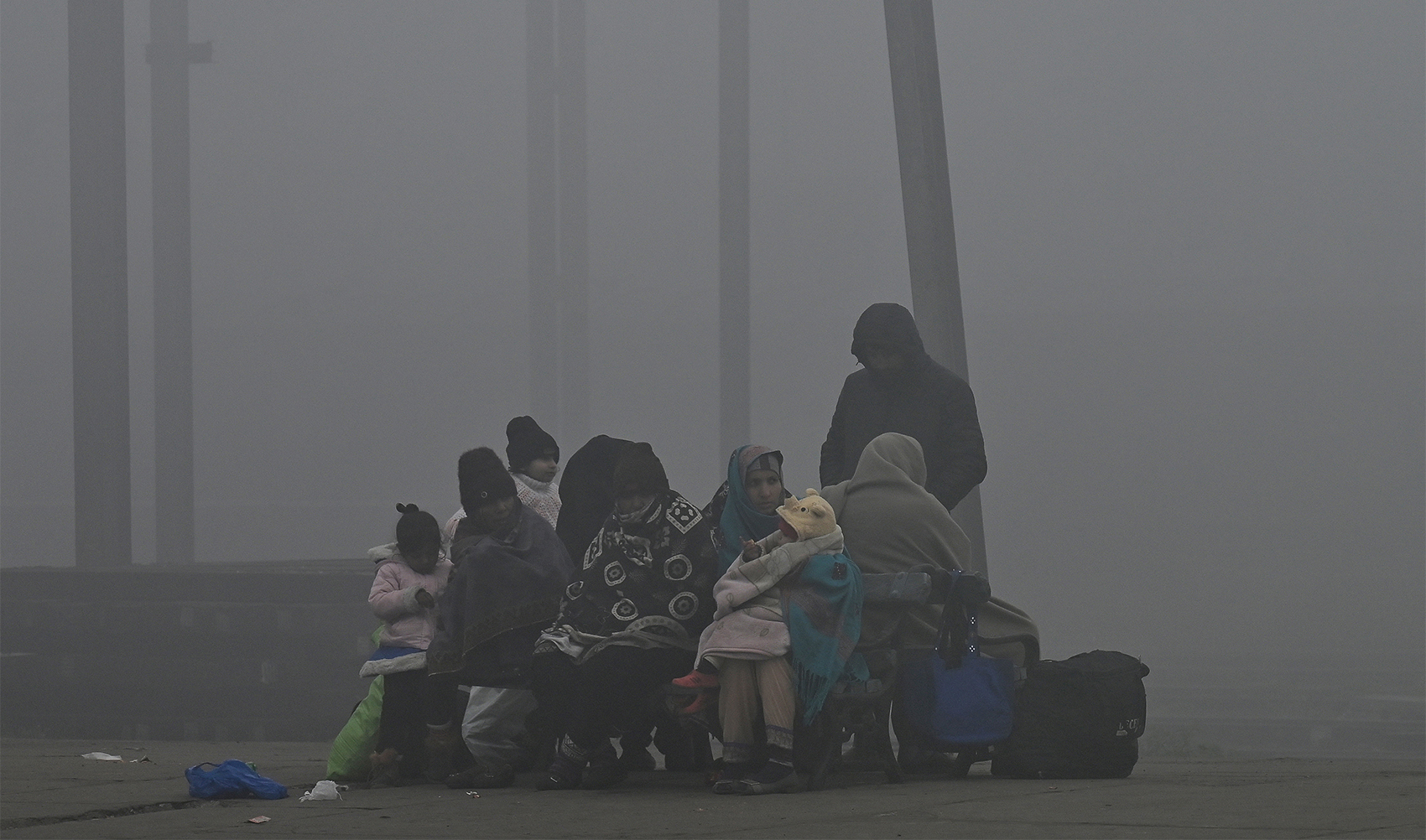 Passengers wait for a train at a railway station amid heavy smog conditions in Lahore January 17, 2024. (AFP/File)
