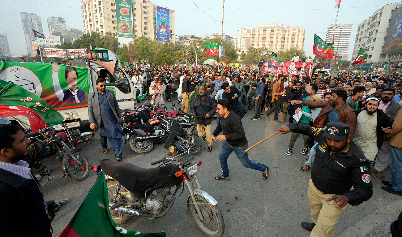 Pakistani Police disperse supporter of former prime minister Imran Khan and political party Pakistan Tehreek-e-Insaf (PTI) during an election campaign rally in Karachi, Pakistan, Sunday, Jan. 28, 2024. (AP)