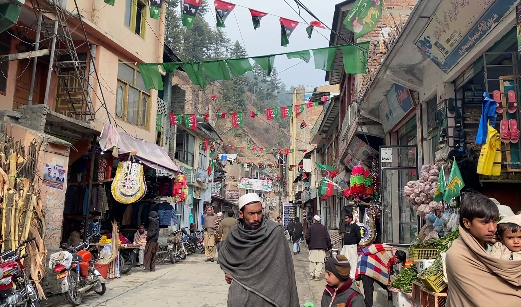A street is festooned with flags of political parties ahead of Pakistan's national elections 2024, in its northwestern Shangla district on January 28, 2024. (AN photo)