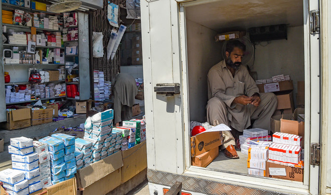 A worker arranges medicine supplies inside a vehicle before distribution at a market in Peshawar on September 1, 2021. (AFP/File)