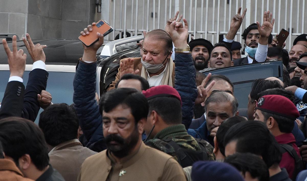 In this file photo, taken on December 12, 2023, Pakistan's former Prime Minister Nawaz Sharif (center) waves to his supporters as he leaves after a court hearing in Islamabad. (AP/File)