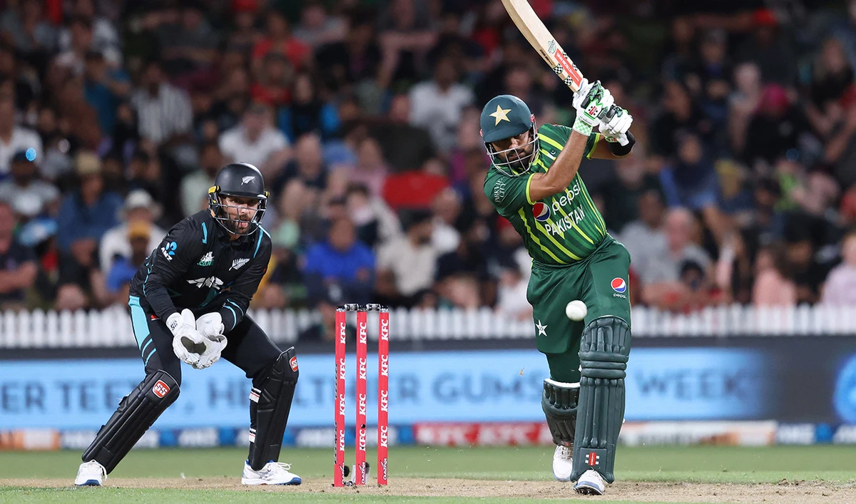 Pakistan's Babar Azam bats while being watched by New Zealand wicketkeeper Devon Conway (L) during the second Twenty20 international cricket match between New Zealand and Pakistan at Seddon Park in Hamilton on January 14, 2024. (AFP)