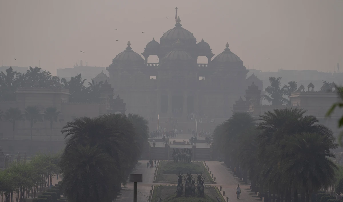 People visiting the Akshardham temple are visible through a thick smog in New Delhi, India, Wednesday, Nov. 8, 2023. (AP)