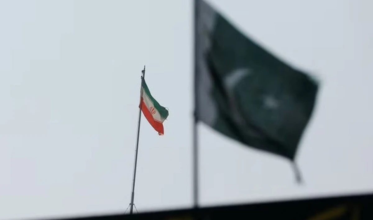 The flag of Iran is seen over its consulate building, with Pakistan's flag in the foreground, in Karachi, Pakistan on January 18, 2024. (REUTERS/File)