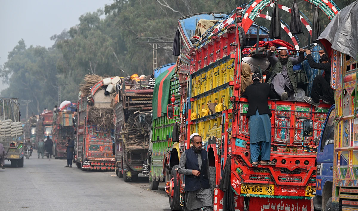 This photo taken on November 23, 2023 shows Afghan refugee on a truck after visiting the United Nations High Commissioner for Refugees (UNHCR) Azakhel Voluntary Repatriation Centre in Nowshera, Pakistan. (AFP/File)